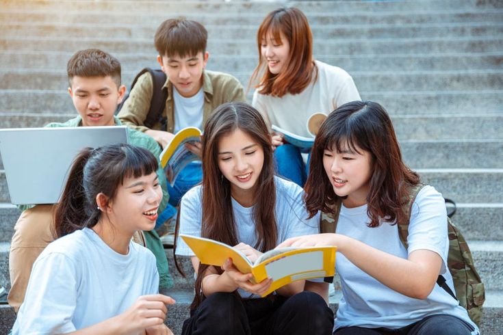 Group of students studying on the stairs  at campus